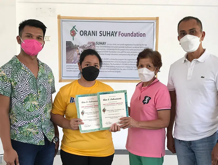 Group of people holding up a certificate